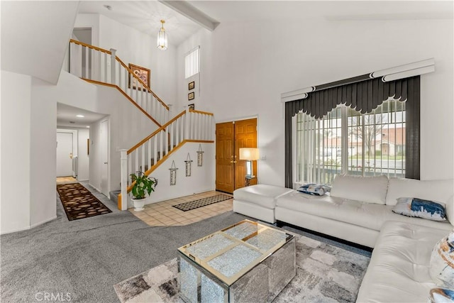 living room with beamed ceiling, a healthy amount of sunlight, high vaulted ceiling, and carpet flooring