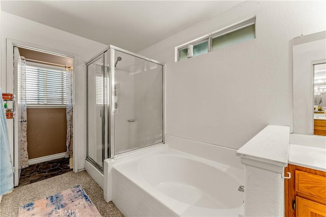 bathroom featuring vanity, independent shower and bath, and a wealth of natural light