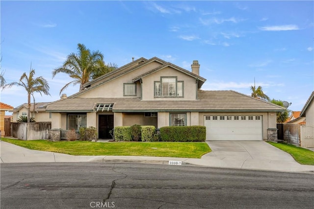 view of front facade with a garage and a front yard