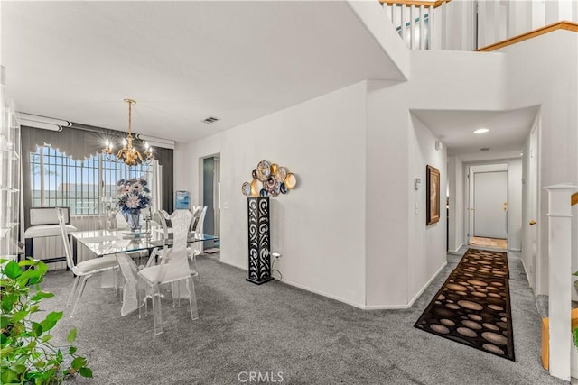 carpeted dining space featuring a notable chandelier