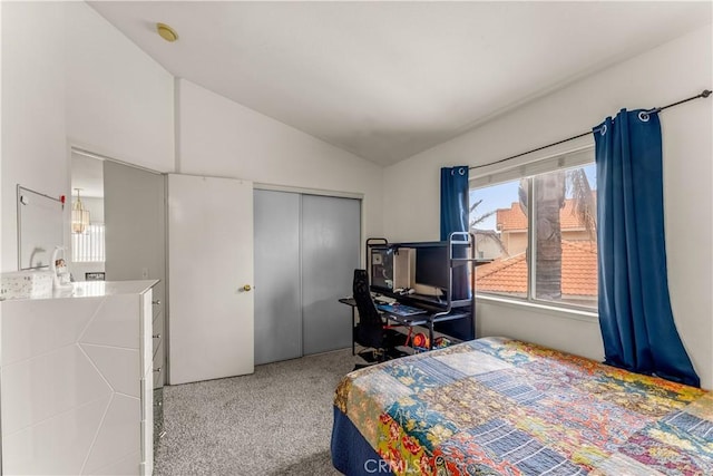 carpeted bedroom with vaulted ceiling and a closet