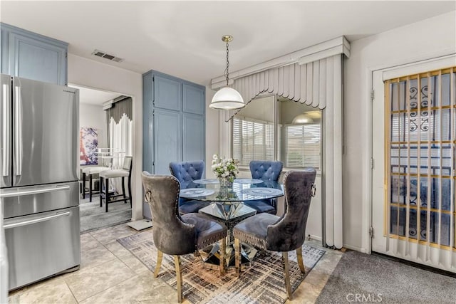 dining space featuring light tile patterned floors