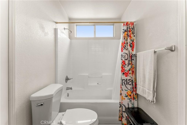 bathroom featuring shower / bath combination with curtain and toilet