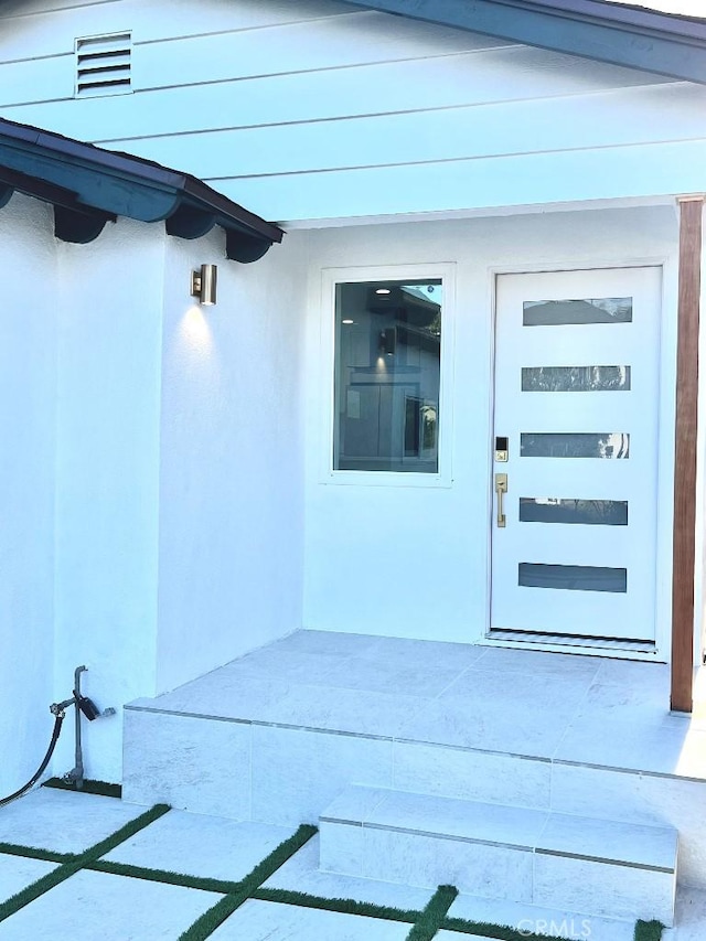 doorway to property with a patio