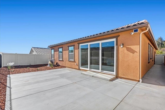 back of house with a patio