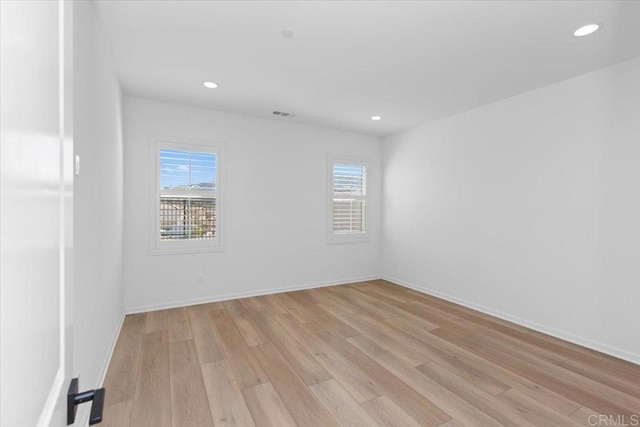 unfurnished room with light hardwood / wood-style flooring