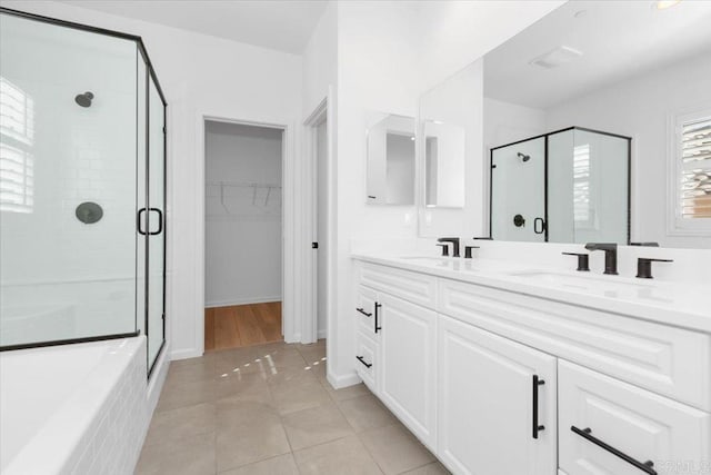 bathroom featuring vanity, an enclosed shower, and tile patterned flooring