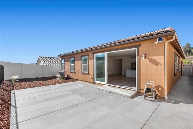 rear view of property featuring a patio area