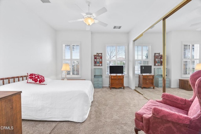 bedroom featuring carpet flooring, ceiling fan, and a closet