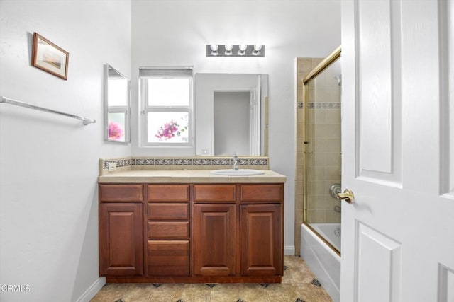 bathroom with vanity and combined bath / shower with glass door