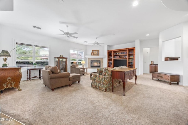 carpeted living room with ceiling fan