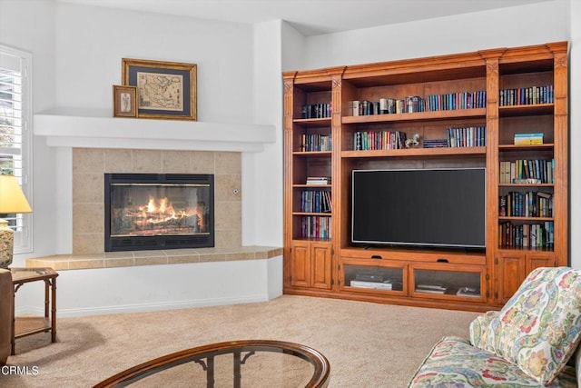 carpeted living room featuring a fireplace