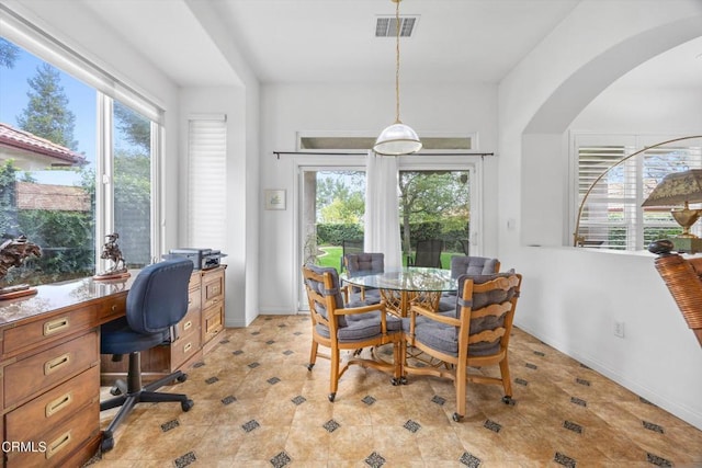 tiled dining area featuring a healthy amount of sunlight