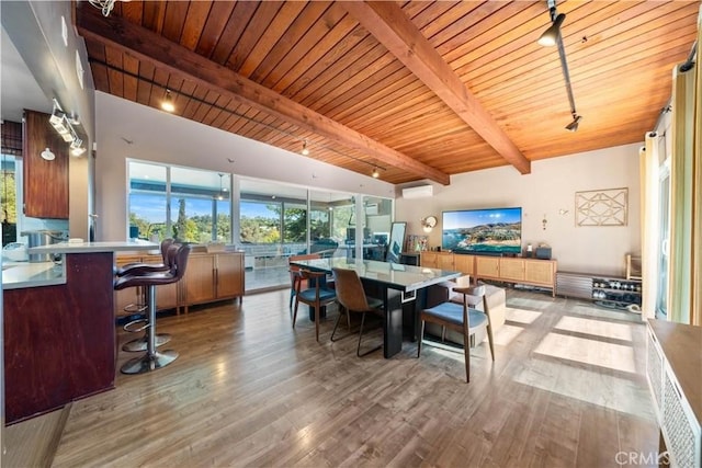 dining space featuring wood ceiling, beam ceiling, light hardwood / wood-style floors, and rail lighting