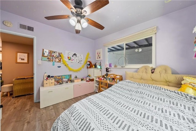 bedroom with ceiling fan and light wood-type flooring