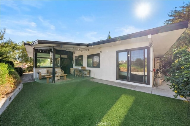 back of house featuring a patio and a yard