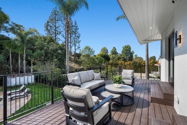 wooden deck with a yard and outdoor lounge area