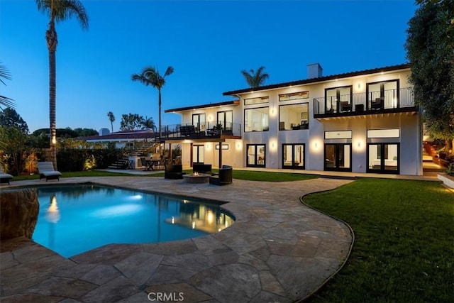 view of pool featuring stairs, a yard, a patio area, and a fenced in pool