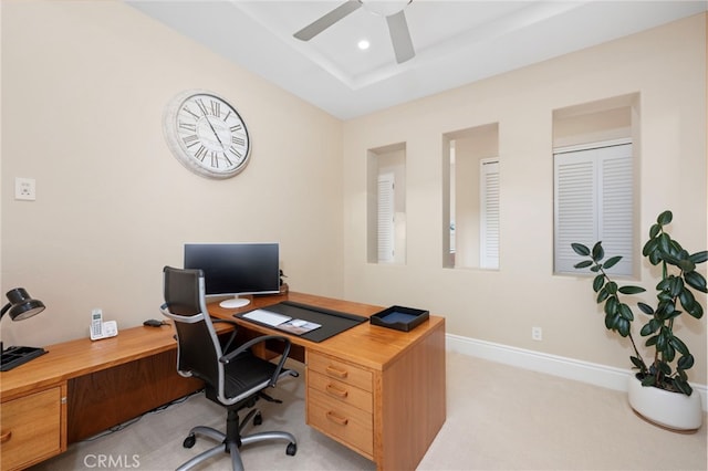 office with recessed lighting, a tray ceiling, a ceiling fan, baseboards, and light colored carpet