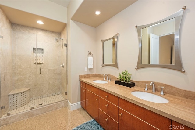 bathroom with recessed lighting, a sink, double vanity, and a stall shower
