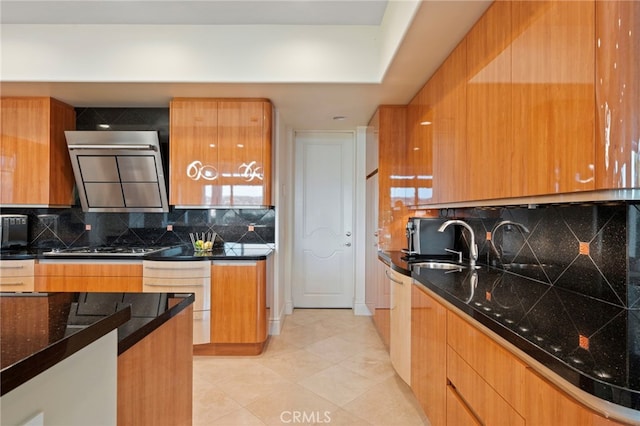 kitchen with modern cabinets, decorative backsplash, range hood, and a sink