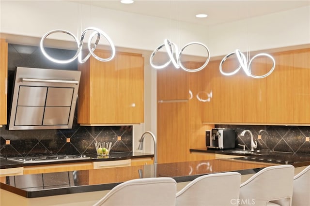 kitchen with recessed lighting, a sink, modern cabinets, stainless steel gas cooktop, and tasteful backsplash