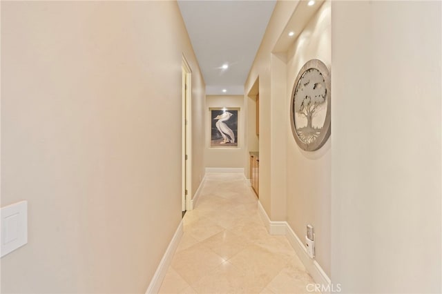 hall with light tile patterned floors, baseboards, and recessed lighting