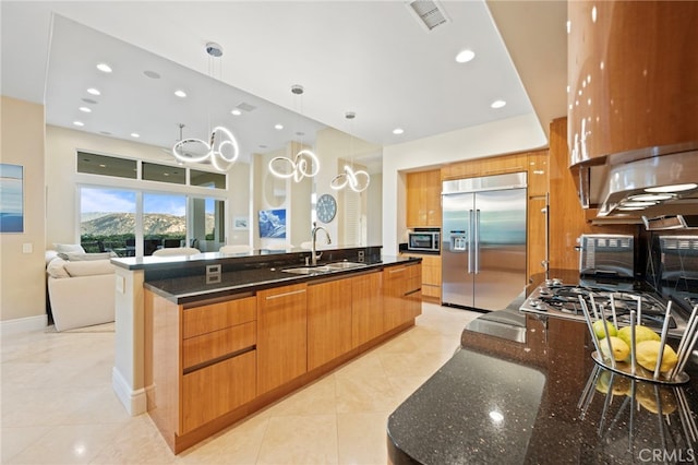 kitchen featuring a sink, light tile patterned floors, modern cabinets, stainless steel appliances, and visible vents