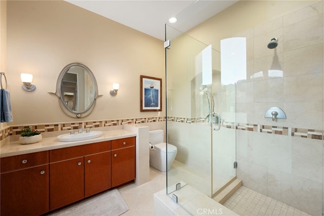 full bath featuring toilet, tile walls, a stall shower, tile patterned flooring, and vanity