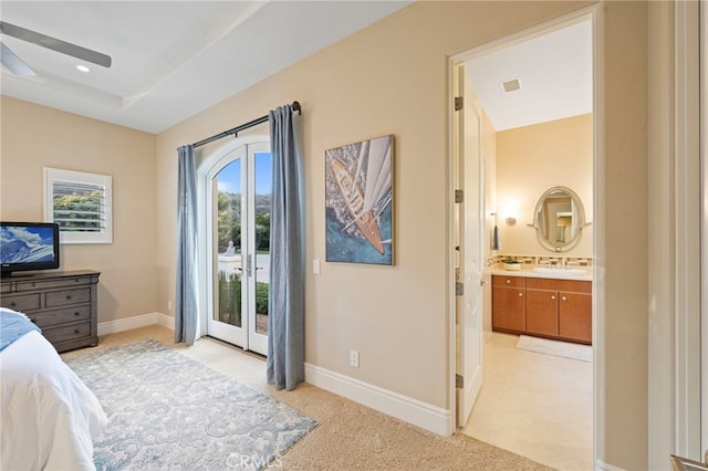 bedroom featuring ensuite bathroom, baseboards, visible vents, light colored carpet, and access to outside