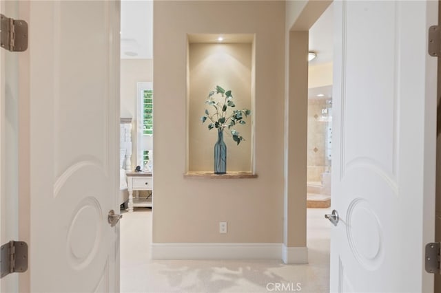 corridor featuring baseboards