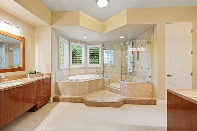bathroom with a garden tub, vanity, and a stall shower