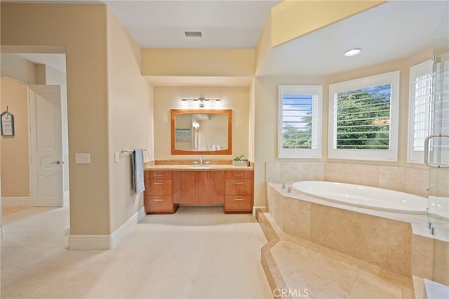 full bathroom with a garden tub, vanity, and visible vents