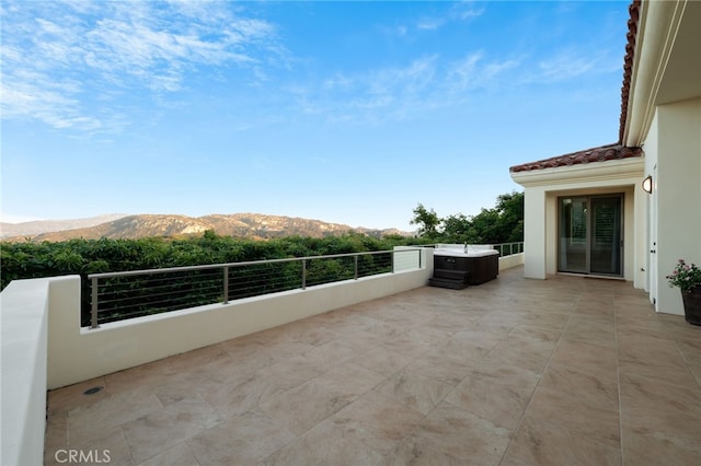 view of patio / terrace with a balcony and a mountain view