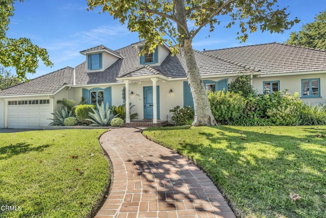 view of front of property with a garage and a front lawn