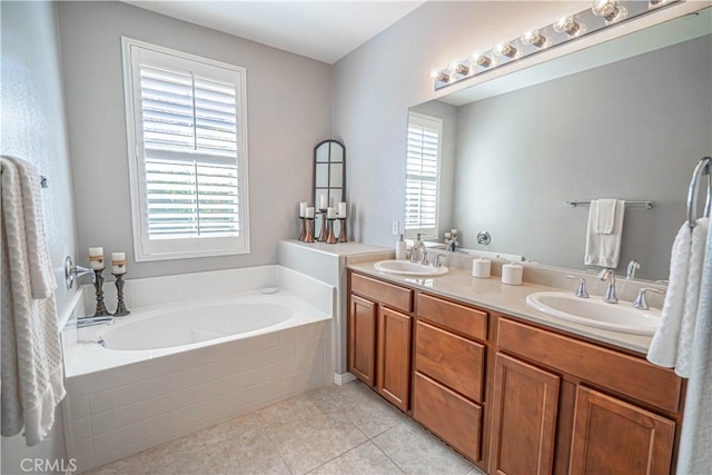 full bathroom featuring a sink, double vanity, a garden tub, and a healthy amount of sunlight