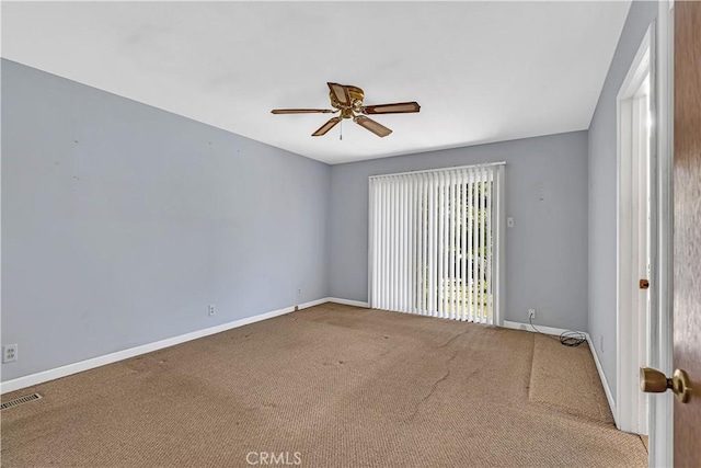 spare room featuring carpet floors and ceiling fan