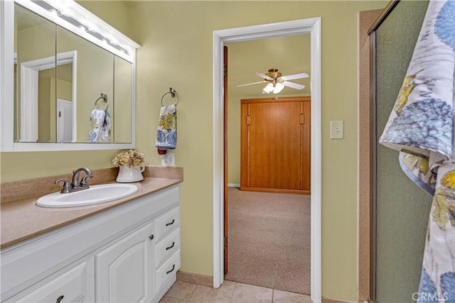 bathroom featuring walk in shower, tile patterned floors, vanity, and ceiling fan