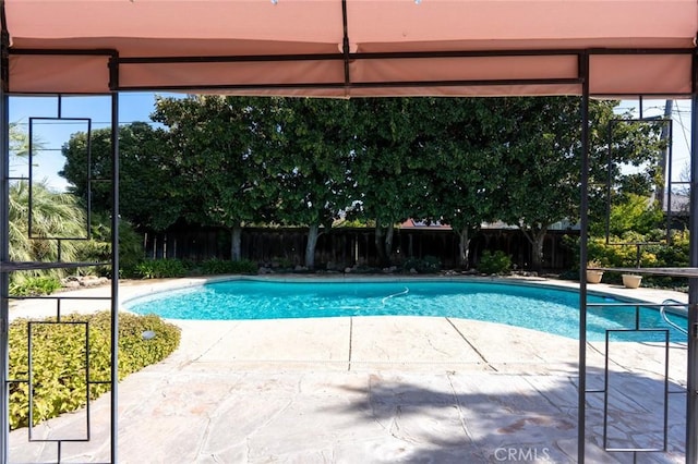 view of swimming pool with a patio area