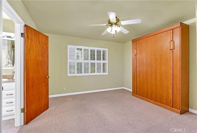 unfurnished bedroom with ceiling fan, a closet, and light carpet