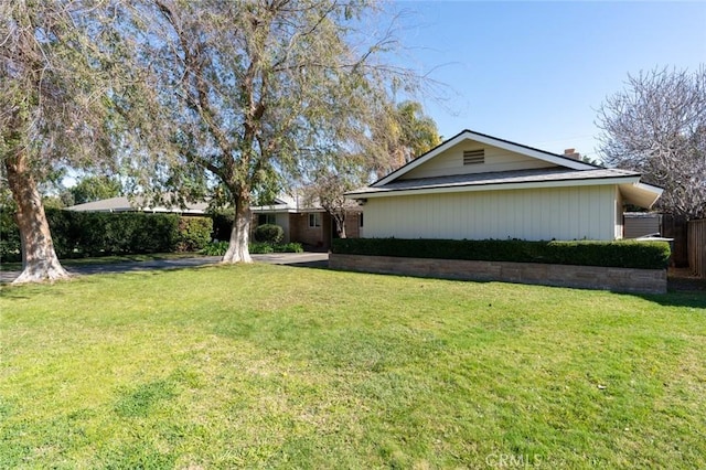 view of side of property with a lawn