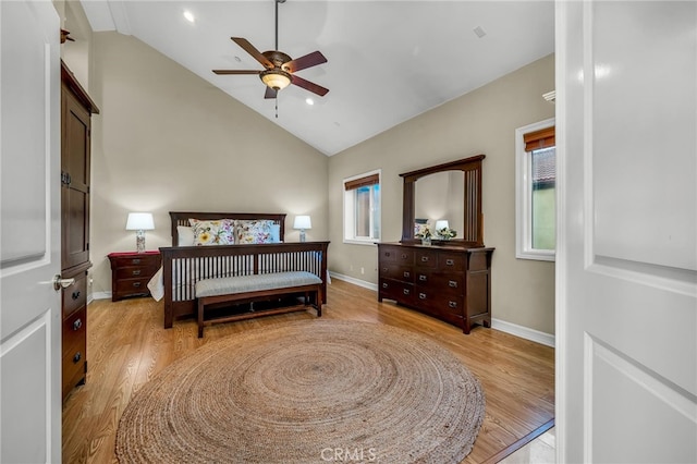 bedroom featuring ceiling fan, high vaulted ceiling, and light wood-type flooring