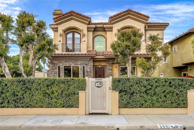 mediterranean / spanish-style home featuring a balcony