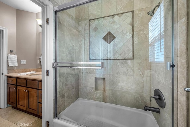 bathroom with vanity, tile patterned flooring, and combined bath / shower with glass door