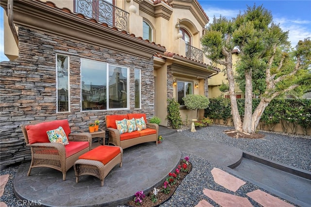 view of patio featuring a balcony and an outdoor hangout area