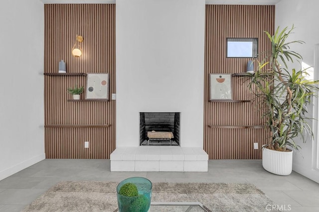 living room featuring a fireplace with raised hearth