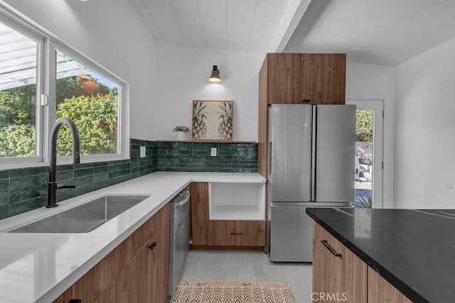 kitchen with light tile patterned flooring, appliances with stainless steel finishes, modern cabinets, and a sink