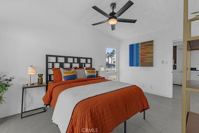 tiled bedroom featuring lofted ceiling, a ceiling fan, and baseboards