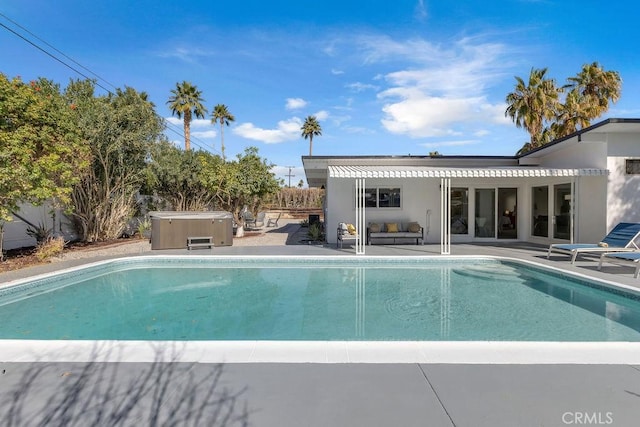 pool with a pergola, a hot tub, a patio, and fence