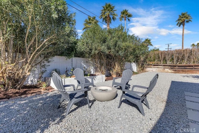 view of patio with a fire pit and a fenced backyard